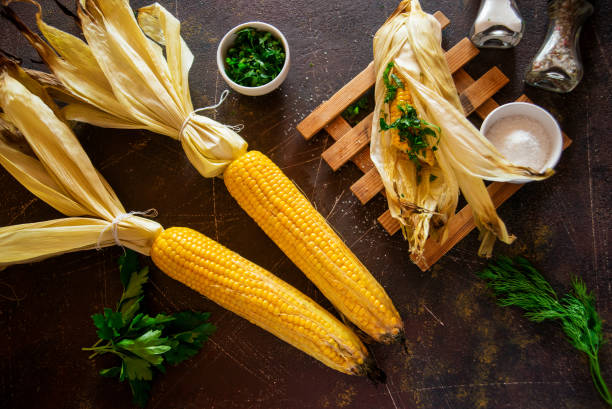 istock Grilled corn with herbs and spices on a dark background. 1037449176