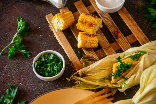 istock Grilled corn with herbs and spices on a dark background. 1037449198