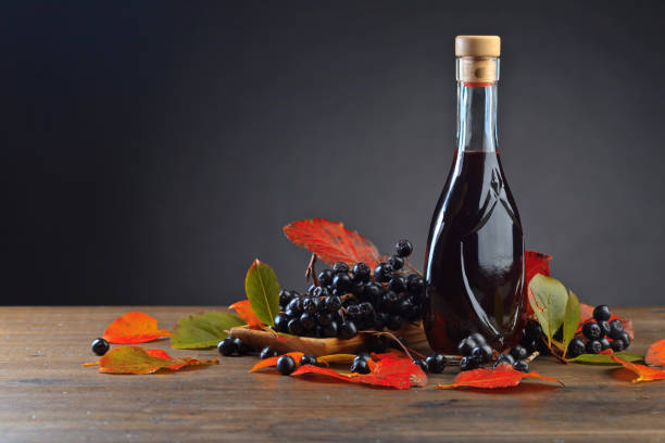 istock Black chokeberry and bottle with juice . 1037462348