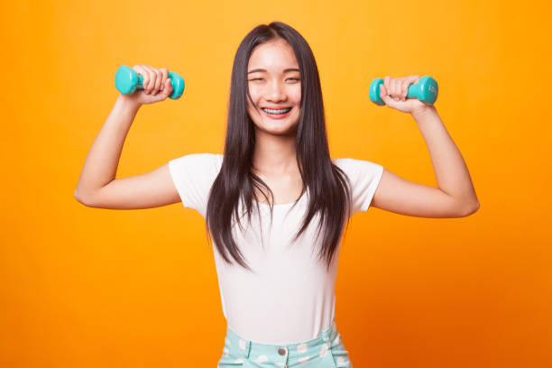 istock Healthy Asian woman with dumbbells. 1037462368