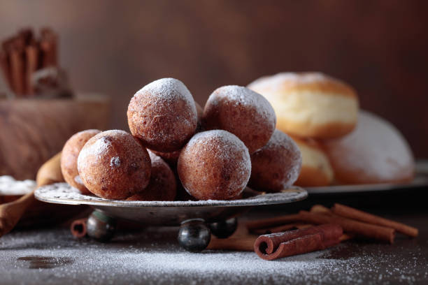 istock Sweet donuts with cinnamon sticks powdered with sugar. 1037470598