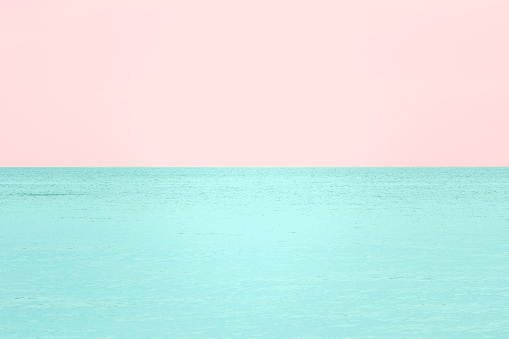 Abstract Pastel Colored Seascape Background - sea and sky wallpaper in trendy pink and aqua colors; toned image.