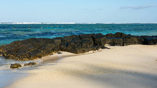 Volcanic rocks on the east coast beach of Poste Lafayette in Mauritius.