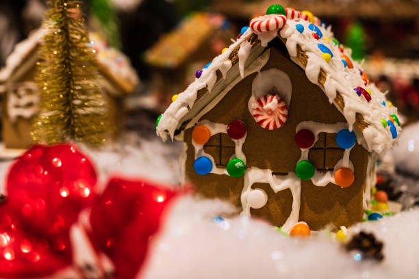 istock Christmas decorations against blurred background. Ginger houses with candies. 1037479996