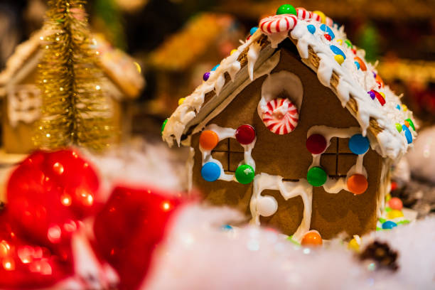 istock Christmas decorations against blurred background. Ginger houses with candies. 1037480270