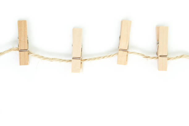 istock clothes pin and brown rope on white background. 1037483782