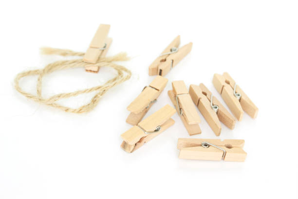istock clothes pin and brown rope on white background. 1037484048