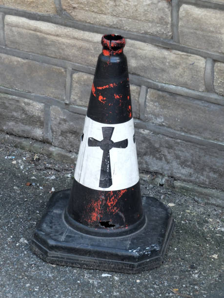 istock a black painted traffic cone with a religious cross painted on it 1037484086