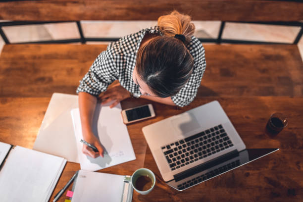 istock Young woman making monthly budget at home 1037487408