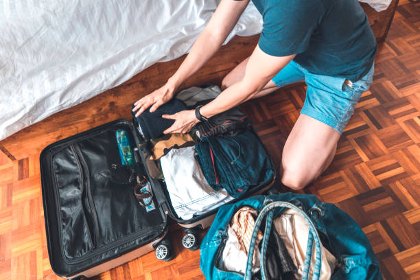 istock Couple packing suitcase for vacation at home 1037487470