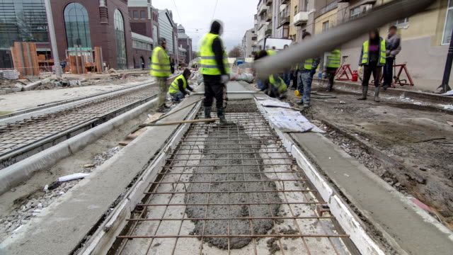 Pouring ready-mixed concrete after placing steel reinforcement to make the road by concrete mixer timelapse hyperlapse