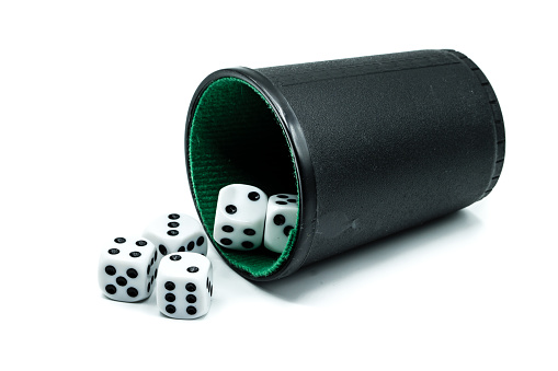 Dice cup with dices isolated on white background