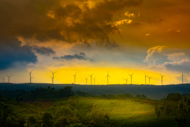 Windmill or wind turbine on mountain on beautiful sunset