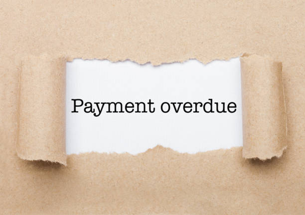 istock Payment Overdue text appearing behind brown paper 1037520750