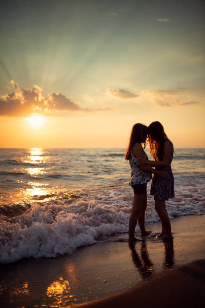 istock Two women on a beach in italy at sunset 1037521008
