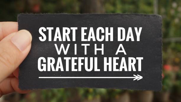 Motivational and inspirational quote. ‘Start each day with a grateful heart’ written on a paper. Vintage styled background. recognition quotes stock pictures, royalty-free photos & images