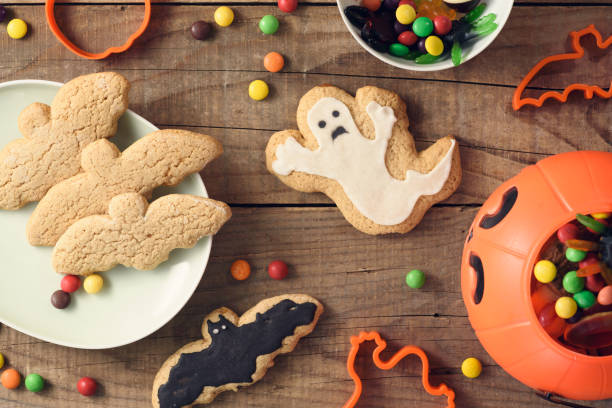 istock Halloween candies on wood table - holiday background 1037524924