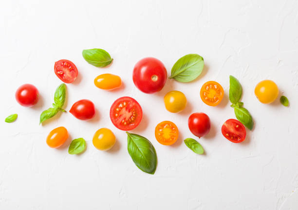 istock Organic Mini Tomatoes with basil and pepper on stone kitchen background. San Marzano, orange and plum tomatoes 1037528710