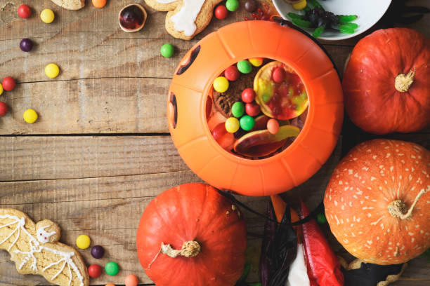 istock Halloween candies on wood table - holiday background 1037529018