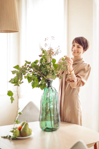 istock Woman is arranging her flowers at home 1037531430