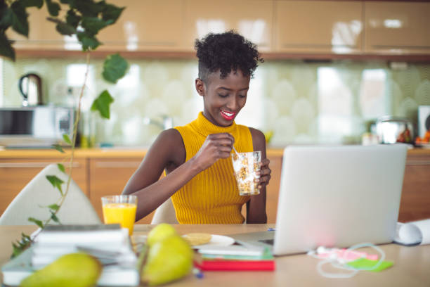 istock Young woman is drinking and working at home 1037533982