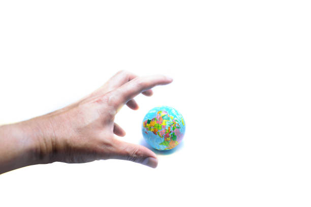 tthe blurred hand with crawling finger gripping the blue globe on white background isolated