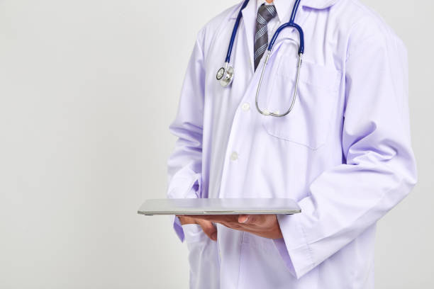 istock Smiling Asians doctor holding a digital tablet 1037540438