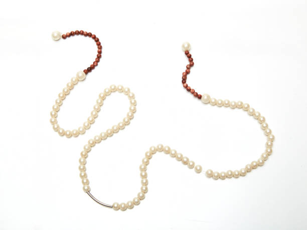 istock NATURAL PEARL NECKLACE ON WHITE BACKGROUND 1037540730
