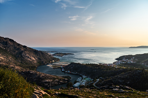 Aerial view of the Ria de Corcubion and Finisterre’s Cape from the top of Mount Pindo at dusk.