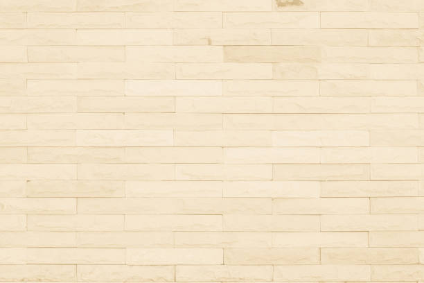 istock Seamless Cream pattern of decorative brick sandstone wall surface with concrete of modern style design decorative uneven have cracked realmasonry wall of multicolored stones or blocks with cement. 1037556996