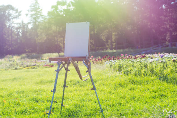 istock Pure white canvas on an easel in a beautiful botanical garden 1037563468