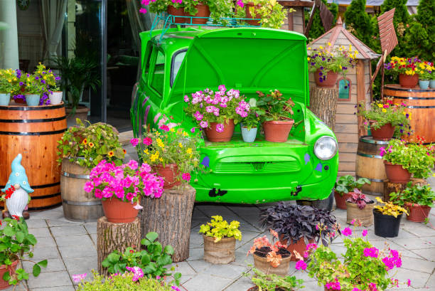 Kazan, Russia - September 9, 2018: Flowrs coemposition with green retro car