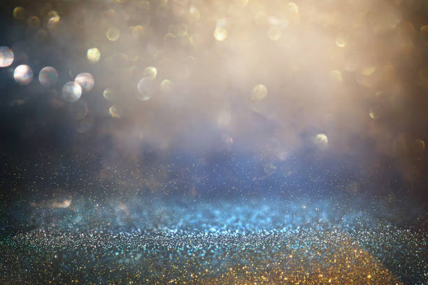 istock glitter vintage lights background. black, blue and gold. de-focused. 1037567646