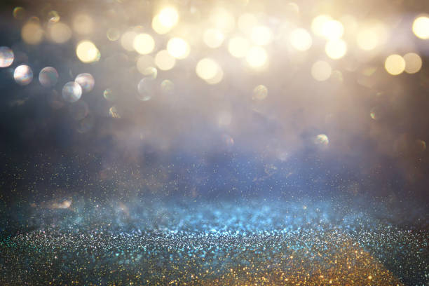 istock glitter vintage lights background. black, blue and gold. de-focused. 1037567682