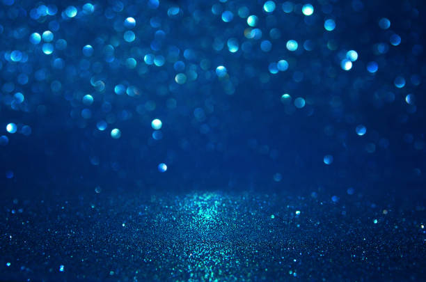 istock glitter vintage lights background. black, blue and silver. de-focused. 1037567712