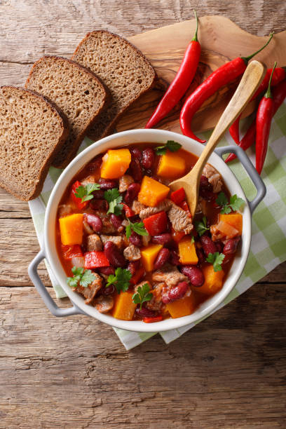 istock Chili con carne with pumpkin closeup in the pan. Vertical top view 1037569012