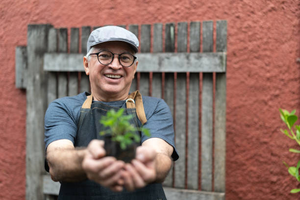 istock Portrait of Farmer Holding Plants 1037572238
