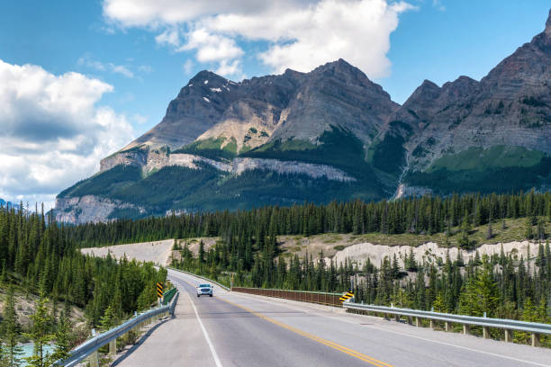 Vehicle Driving on Icefields Parkway Between Banff and Jasper National Parks, Alberta, Canada