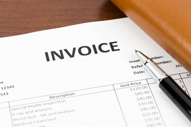 istock Invoice with pen and organizer; invoice is mock-up 1037577362