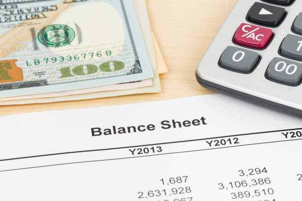 istock Balance sheet financial report with pen, banknote, and calculator 1037585404