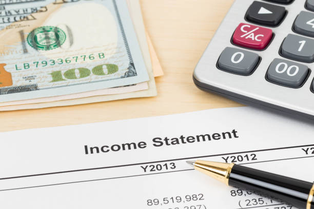 istock Income statement financial report with pen, banknote, and calculator 1037585526