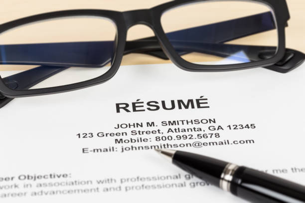 istock Resume with pen and glasses; resume is mock-up 1037585612