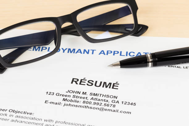 istock Resume with pen and glasses concept job applying 1037585614