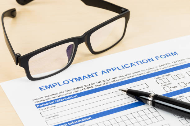 istock Employment application form with pen and glasses concept job applying 1037585620