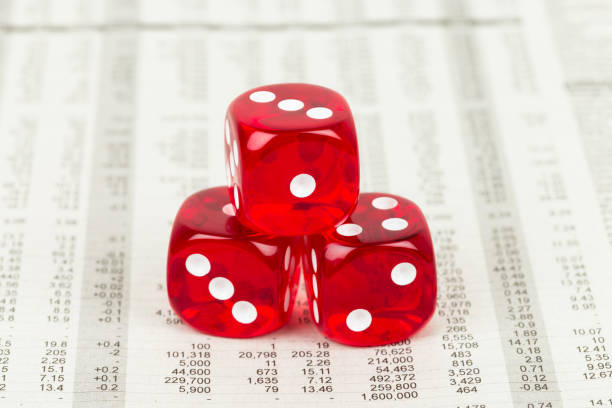 istock Dice stack rest on stock price detail financial newspaper 1037590848