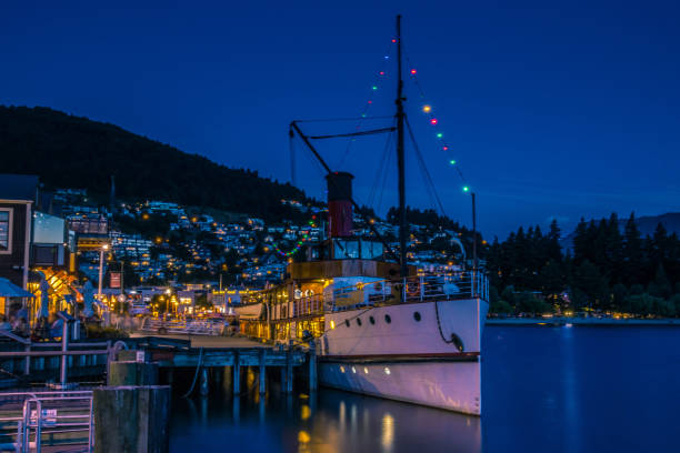 istock Ship near coastal settlement at night 1037594454