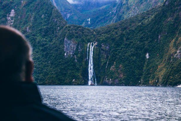 istock Crop person looking at waterfall 1037594494