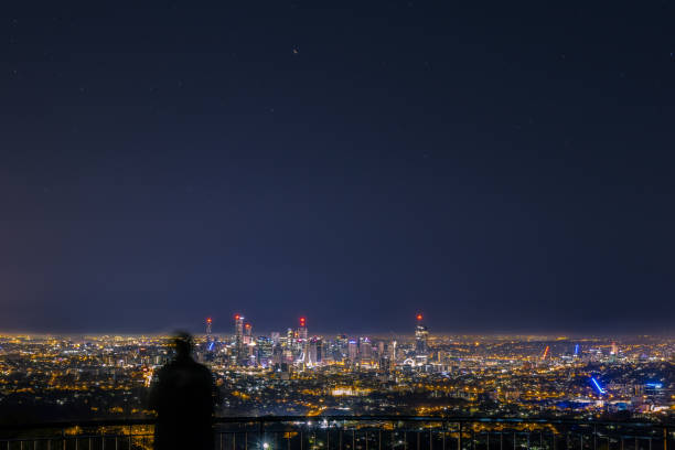 istock Anonymous person looking at night city 1037594496
