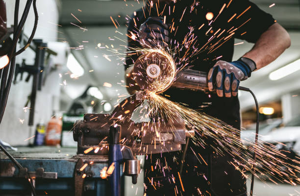 istock Heavy industry worker cutting steel with an angle grinder. 1037604528