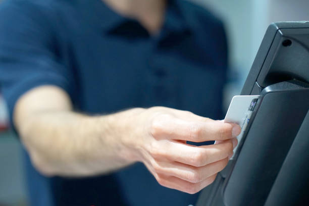 istock Swiping credit card in a reade 1037605534